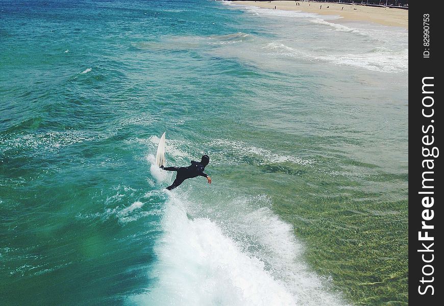 Surfer On Sandy Shores