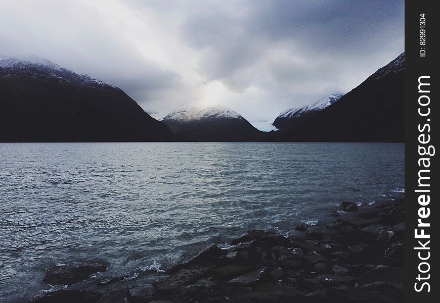 Cloudy Skies Over Alpine Lake