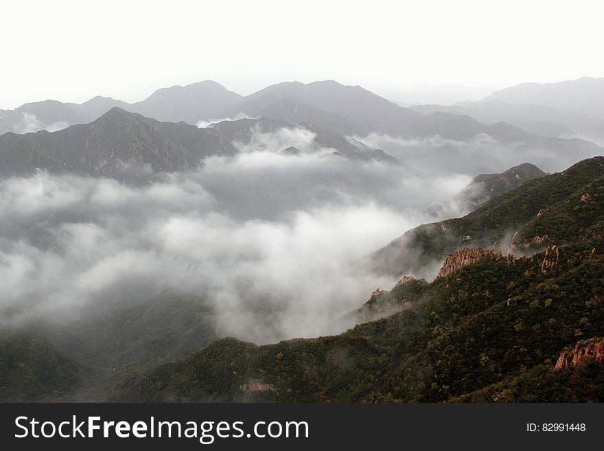 Low clouds in mountain valley on overcast day. Low clouds in mountain valley on overcast day.