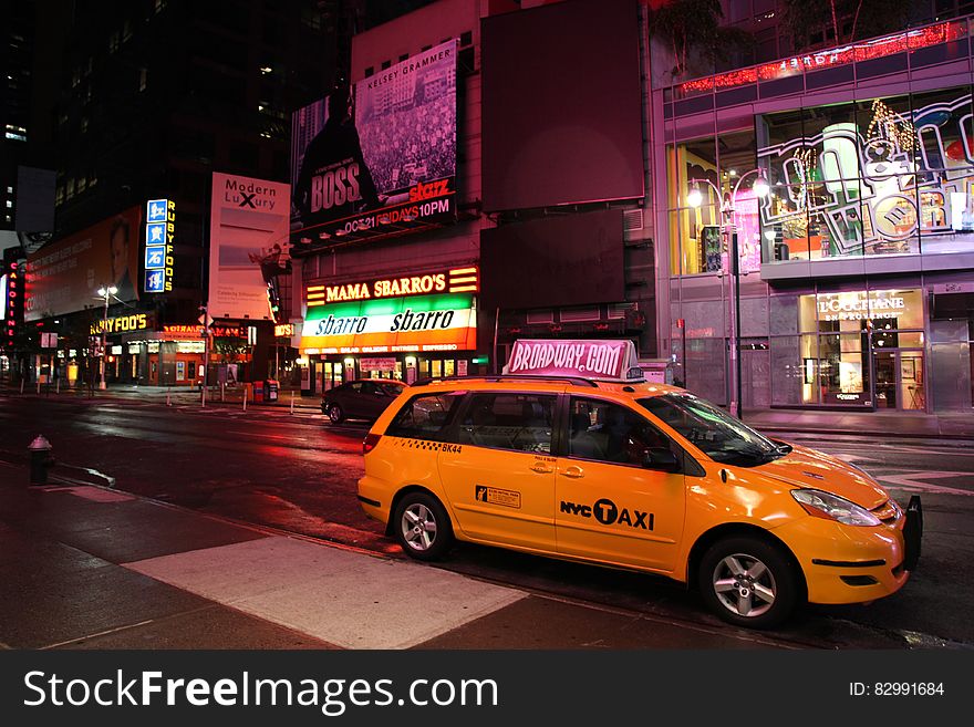 Yellow Hvc Taxi on Road during Night