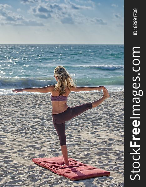 Woman Doing Yuga On Seashore