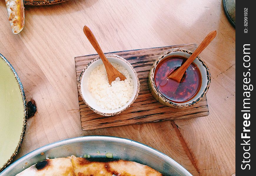 Close up of Asian condiments on wooden table. Close up of Asian condiments on wooden table.