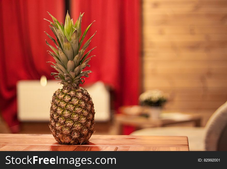 Fresh whole pineapple on wooden table indoors. Fresh whole pineapple on wooden table indoors.