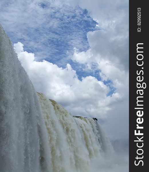 Waterfalls Under Blue Sky With White Clouds during Daytime