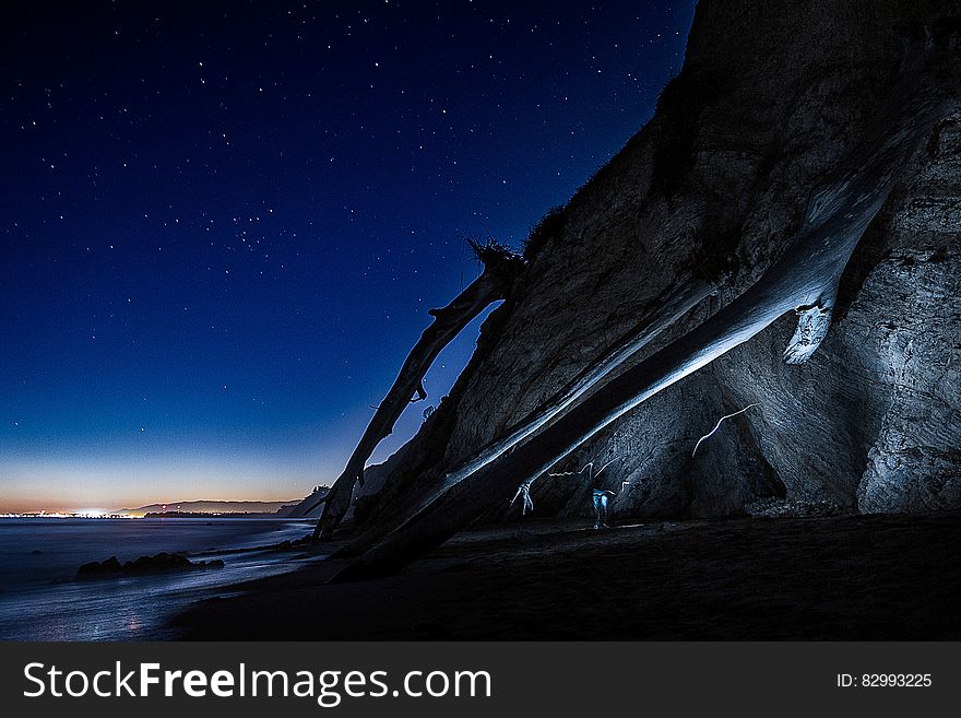 Cliff At Night With Starry Skies