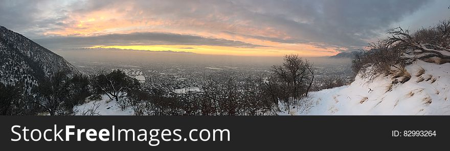 Panorama of snow cover mountain peaks and valley at sunset. Panorama of snow cover mountain peaks and valley at sunset.