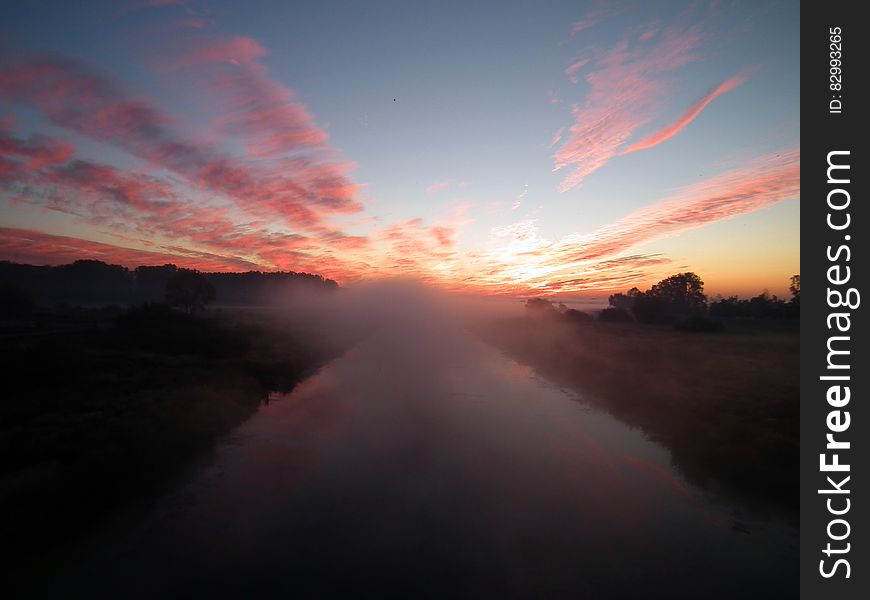 Sun Setting Over White Clouds