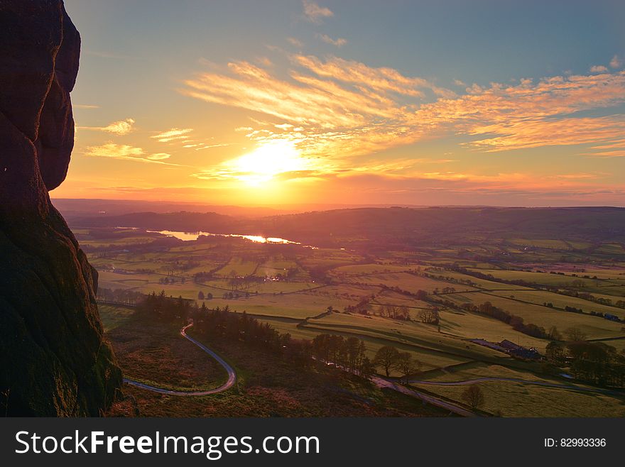 Aerial View Of Green Grass Field During Sunset