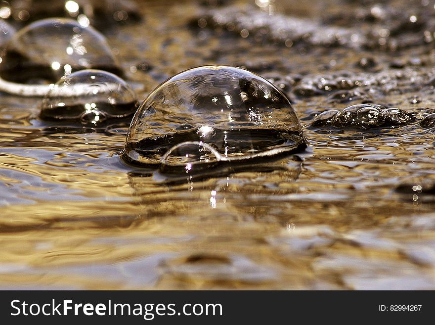 Macro close up of water bubbles on surface.