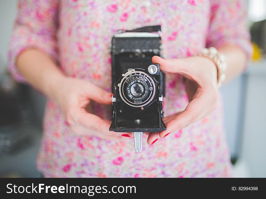Old analog camera in woman&#x27;s hands