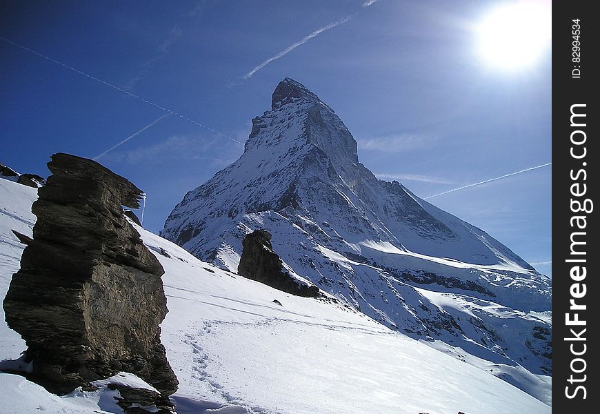 White Snow Near Gray Rock During Daytime