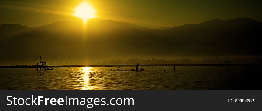 Silhouette of People Riding Boats on Water during Daytime