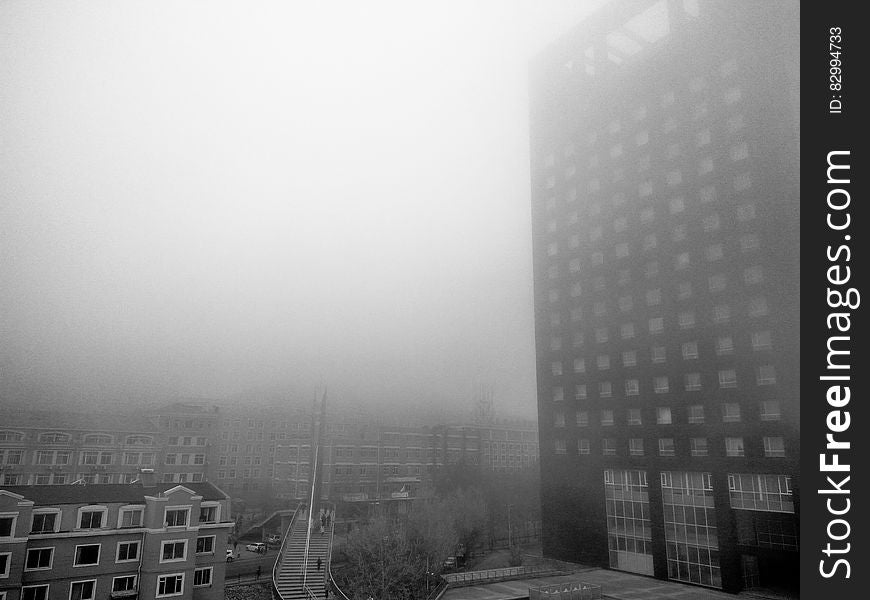 Fog around high rise modern building in black and white. Fog around high rise modern building in black and white.