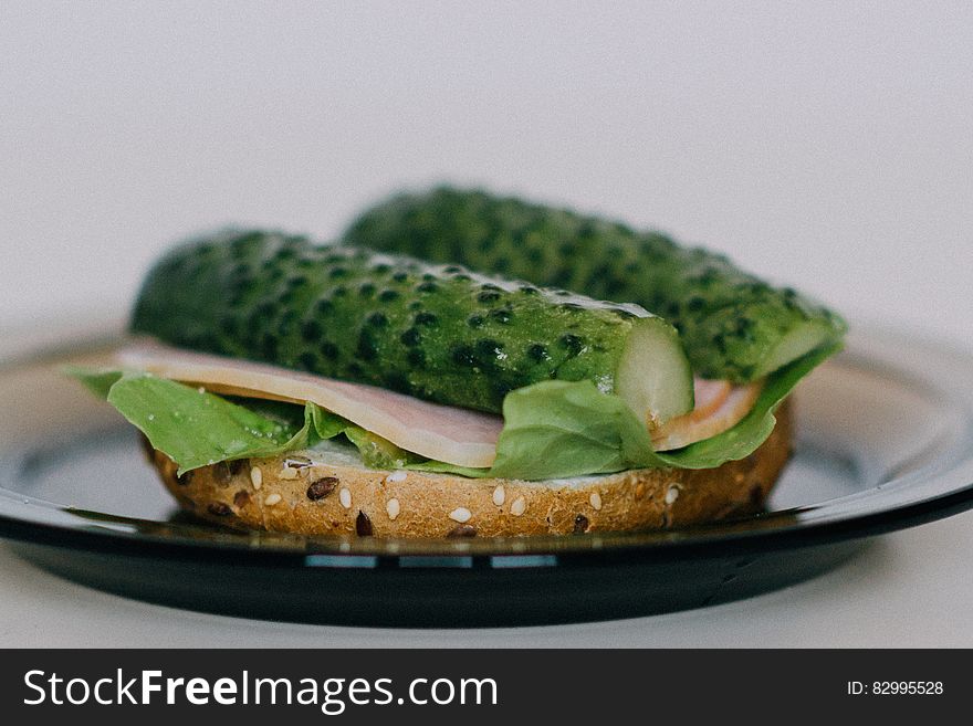 Turkey and gherkin sandwich with lettuce on brown seed bread.