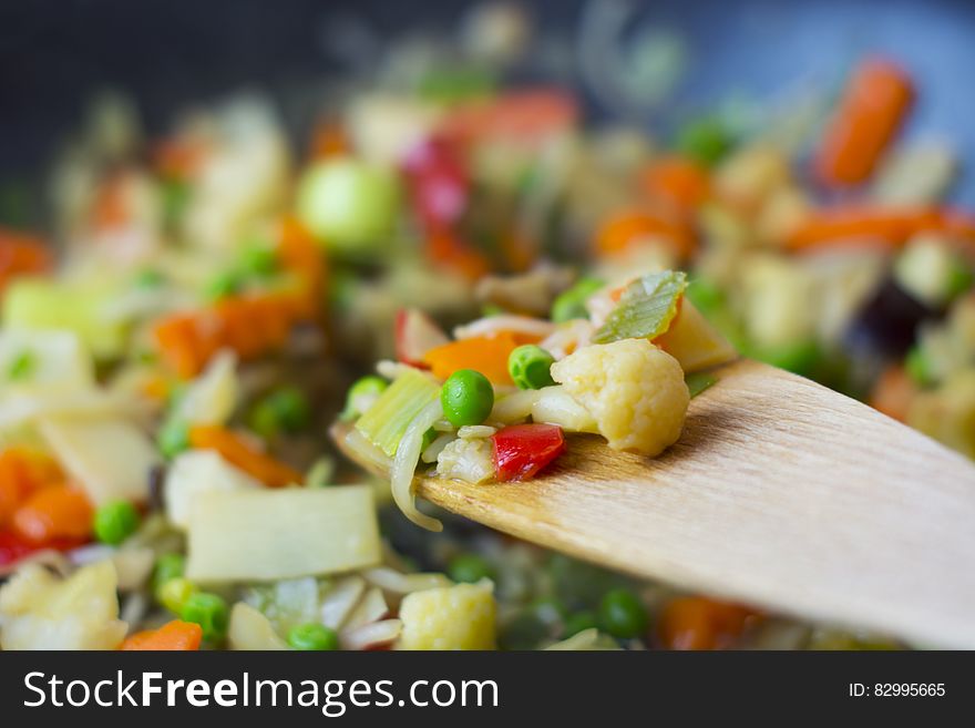Close up of colorful vegetable pieces on wooden spoon. Close up of colorful vegetable pieces on wooden spoon.