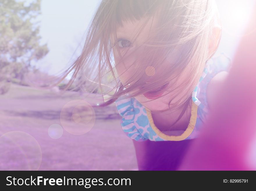 Girl&x27;s In Yellow And Blue Floral Shirt Taking Photo