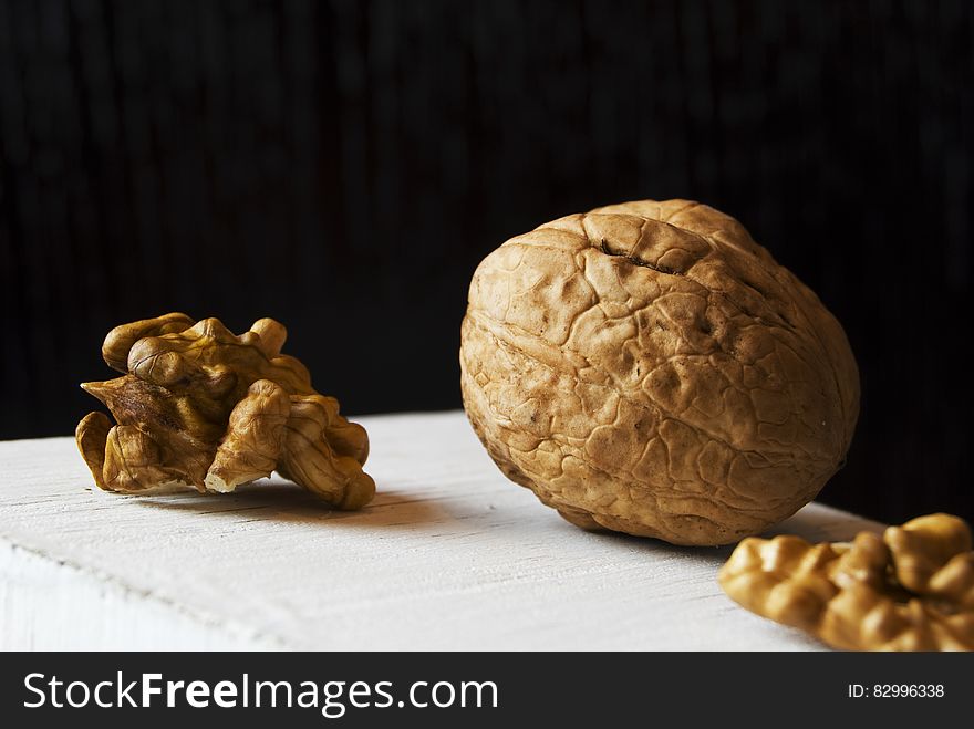 Whole walnut in shell with nut meat pieces on white. Whole walnut in shell with nut meat pieces on white.