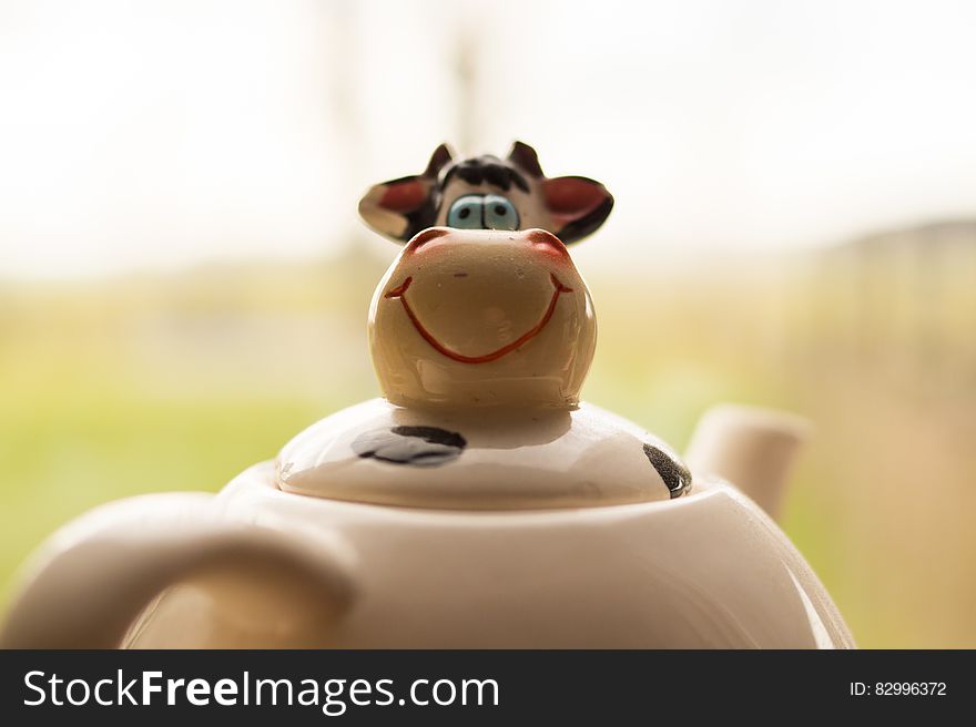 Closeup of funny cows faces on porcelain teapot. Closeup of funny cows faces on porcelain teapot.