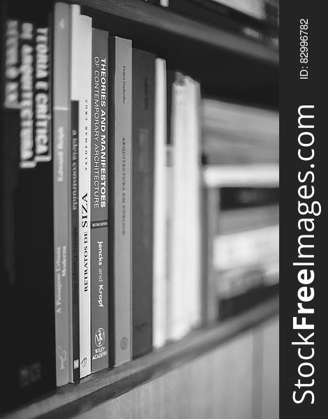 A close up of a bookshelf with various books. A close up of a bookshelf with various books.