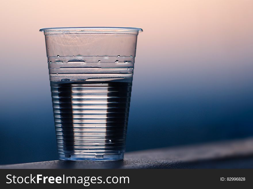 Clear Plastic Cup on Gray Surface