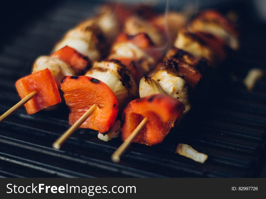 Meat and pepper kebabs on wooden skewers on barbecue grill pan. Meat and pepper kebabs on wooden skewers on barbecue grill pan.