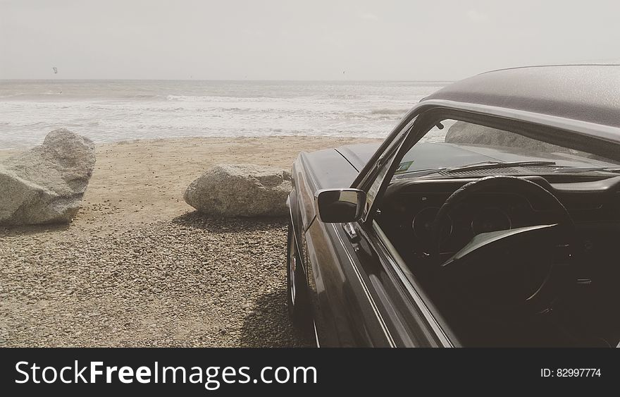 Black Car Parked on the Seashore