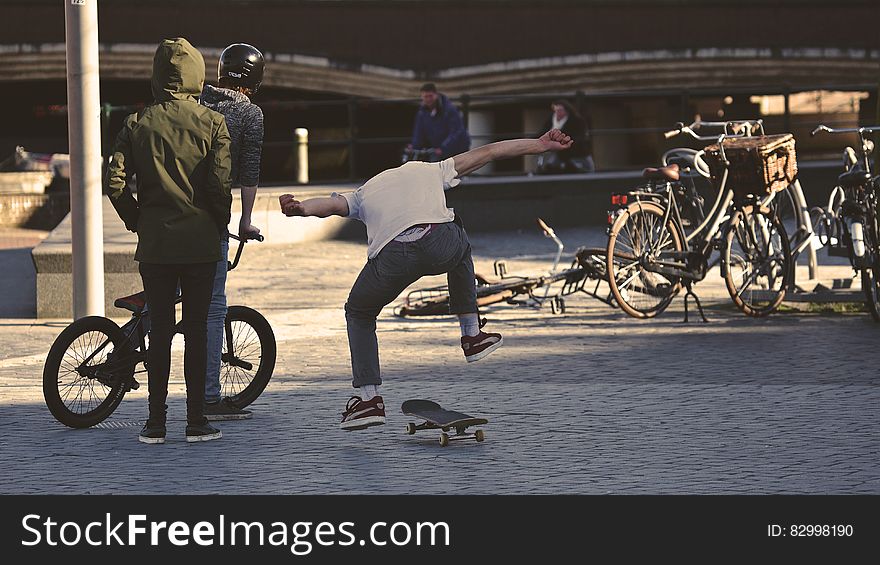 Man in White Shirt Doing Skateboard Trick