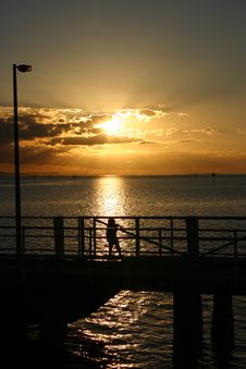 CHILD ON THE JETTY SUNSET Royalty Free Stock Images CHILD ON THE JETTY SUNSET Royalty Free Stock Images