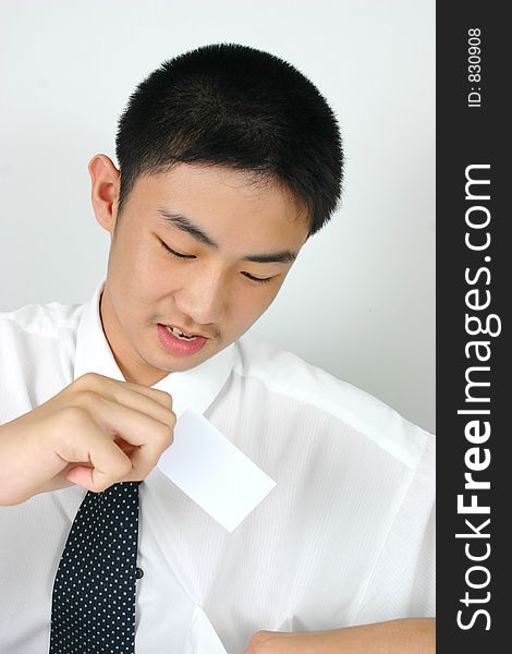 Businessman putting business card in his pocket.