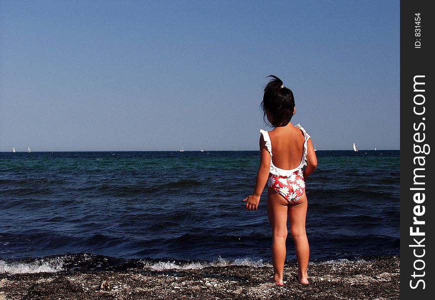 Child playing a summer day at the beach in denmark. Child playing a summer day at the beach in denmark