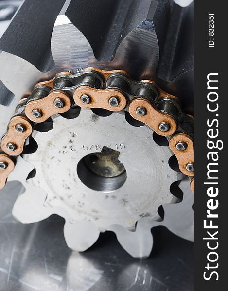 Large chain driving a gear-wheel showing links. Large chain driving a gear-wheel showing links