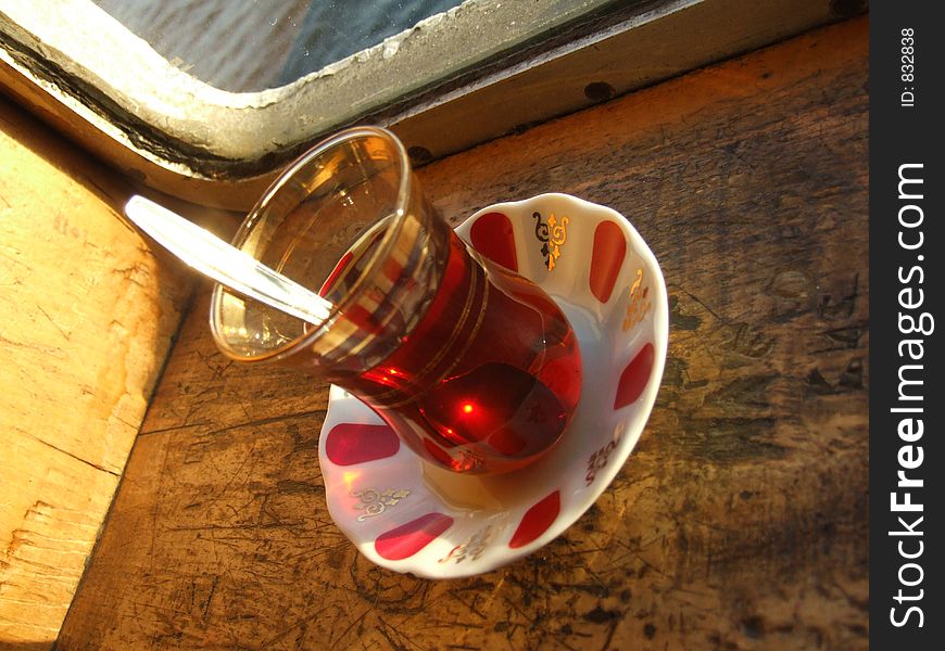 A glass of tea served in traditional Turkish style. A glass of tea served in traditional Turkish style