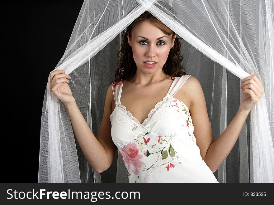 Beautiful young woman posing with white netting. Beautiful young woman posing with white netting