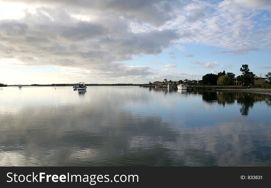 Beautiful Jacob's Well Australia with houseboat sitting in the water.