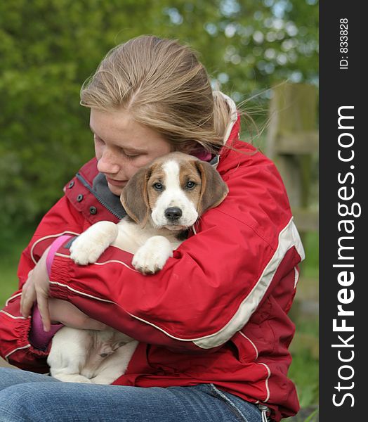 Teenager cuddles her adorable 8 week old puppy. Teenager cuddles her adorable 8 week old puppy