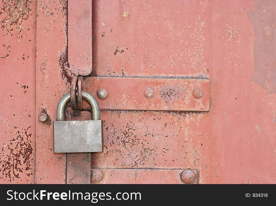 Lock on an old red gate