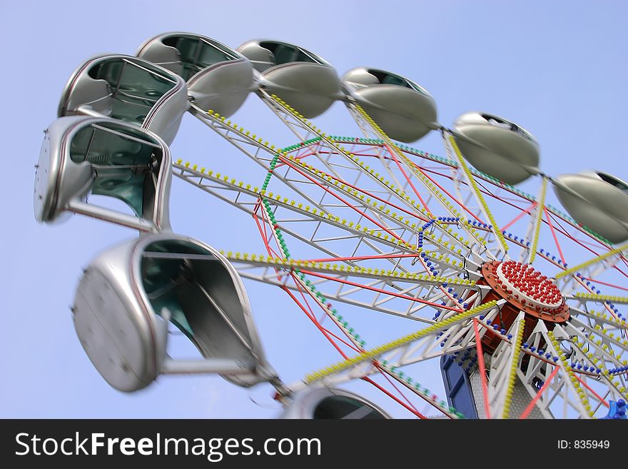 Ferris wheel on a background of the blue sky.