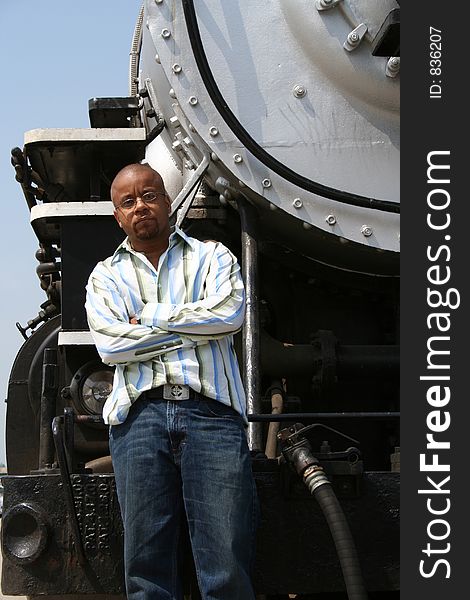 Young man posing on old train locomotive. Young man posing on old train locomotive