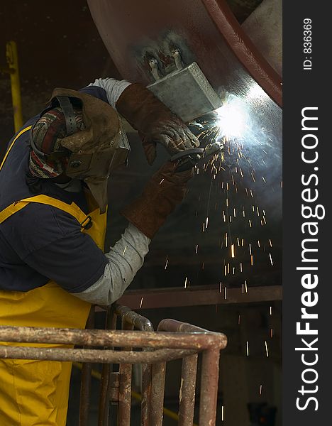 Welder working out of manlift. Welder working out of manlift