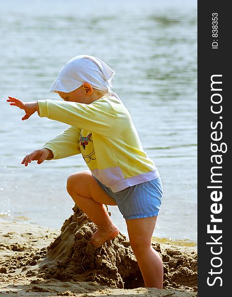 Baby Girl Playing On The Sea Shore