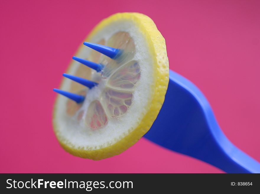 Blue fork and lemon over magenta