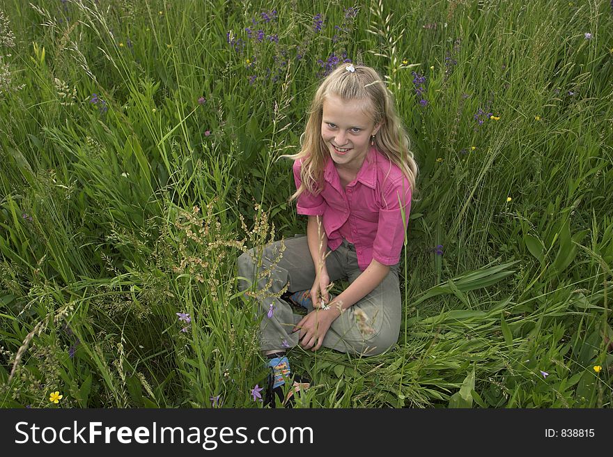 Young girl siting in grass