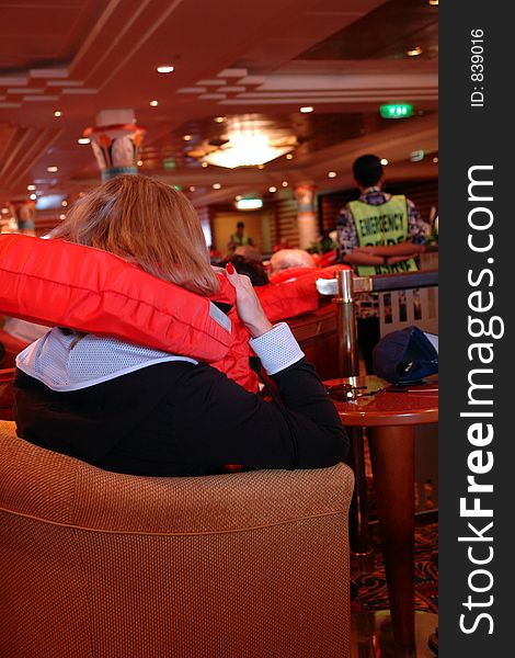 Woman with lifevest during safety drill on cruiseship