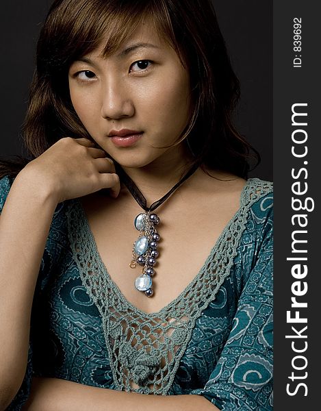 A beautiful young asian woman posing in dress. A beautiful young asian woman posing in dress
