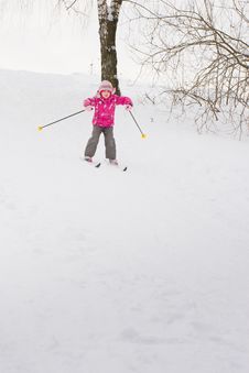 Little Girl Sliding Down Hill On Ski Stock Photo