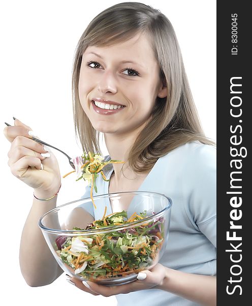 Portrait of young happy woman eating salad