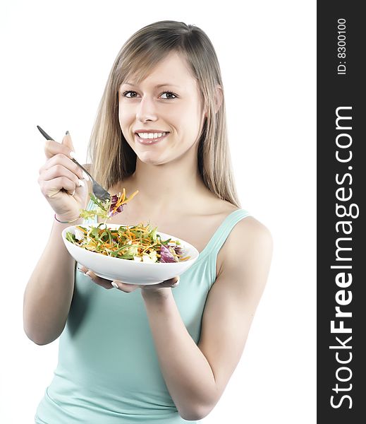 Portrait of young happy woman eating salad