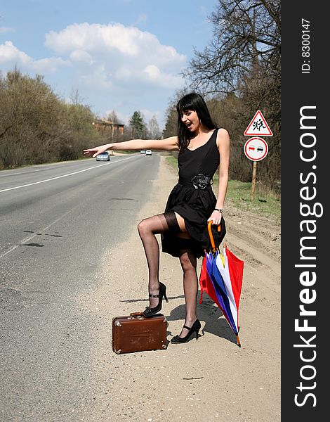 Girl with vintage suitcase and umbrella outdoors. Girl with vintage suitcase and umbrella outdoors