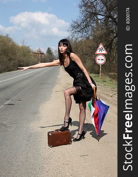 Girl with vintage suitcase and umbrella outdoors. Girl with vintage suitcase and umbrella outdoors