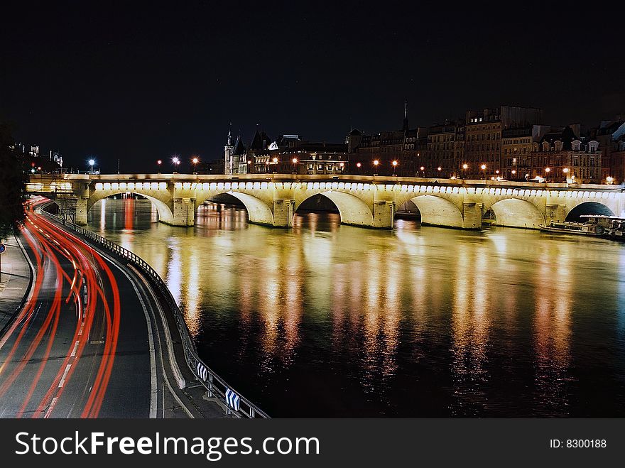 Night sight of Paris with the Conciergeri to the bottom and traffic llghts in the first term of the image. Night sight of Paris with the Conciergeri to the bottom and traffic llghts in the first term of the image